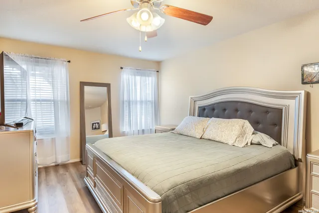a bedroom with a large bed and a chandelier