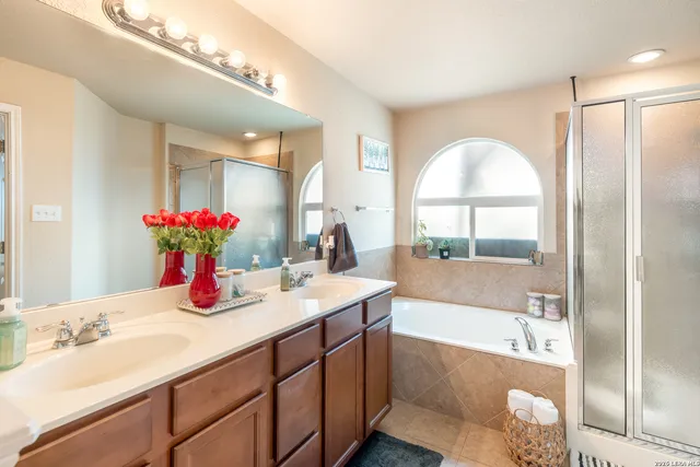 a bathroom with a tub sink and mirror