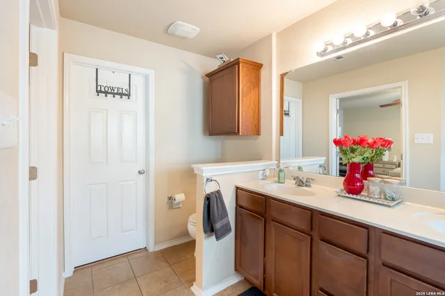 a bathroom with a sink vanity and a mirror