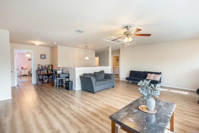 a living room with furniture and kitchen view