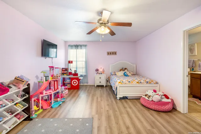 a bedroom with furniture and a wooden floor