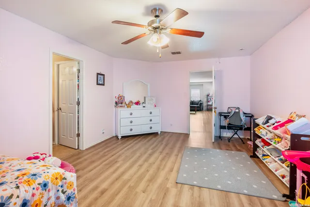 a bedroom with furniture and a baby crib