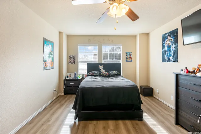 a bedroom with a bed and wooden floor