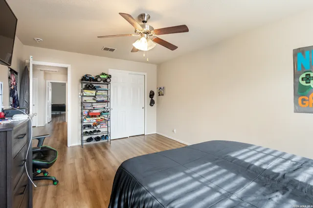 a bedroom with a bed and a ceiling fan
