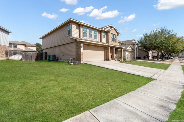a front view of a house with a yard
