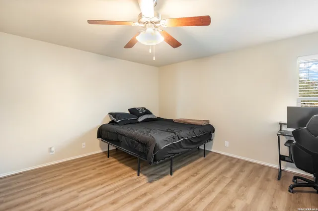 a room with a bed and a ceiling fan
