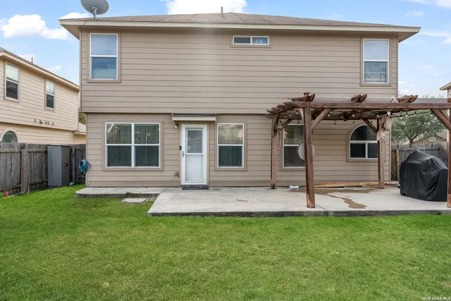 a view of a house with a yard and sitting area