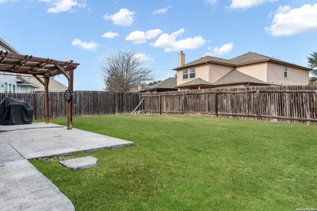 a view of a house with a yard and pathway