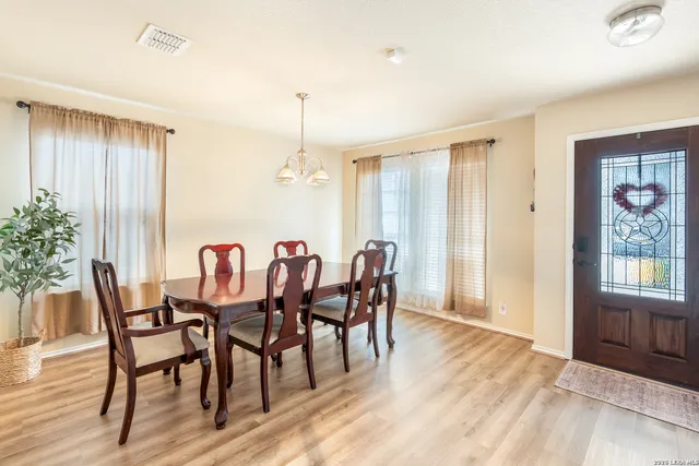 a view of a dining room with furniture and window