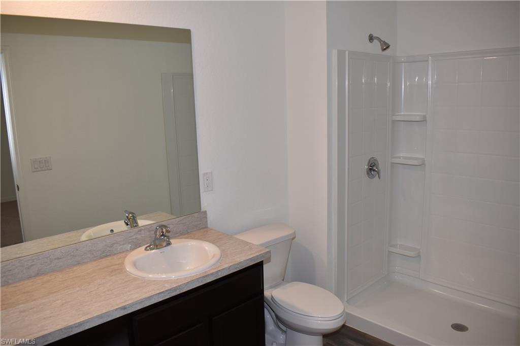 8388 Delong Avenue North Port, FL 34291 - Photo 15 of 21 a bathroom with a sink a toilet and shower