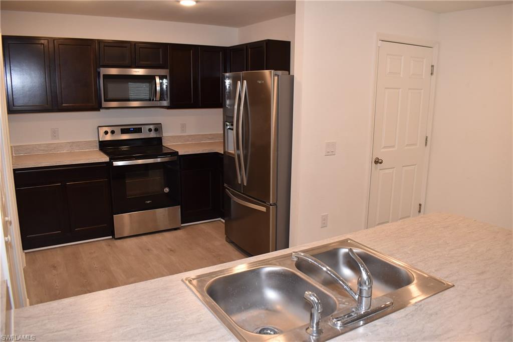 8388 Delong Avenue North Port, FL 34291 - Photo 3 of 21 a kitchen with a refrigerator and a sink