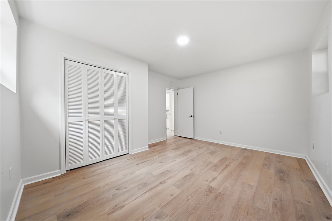 107 Edwards Mill Road Taylors, SC 29687 - Photo 23 of 34 Blonde wood flooring and a louvered bi-fold closet create a well-appointed bedroom interior.