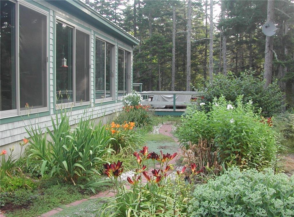 154 Boulder Hill Road Tenants Harbor, ME 04860 - Photo 1 of 16 Garden pathway in front of the sun...