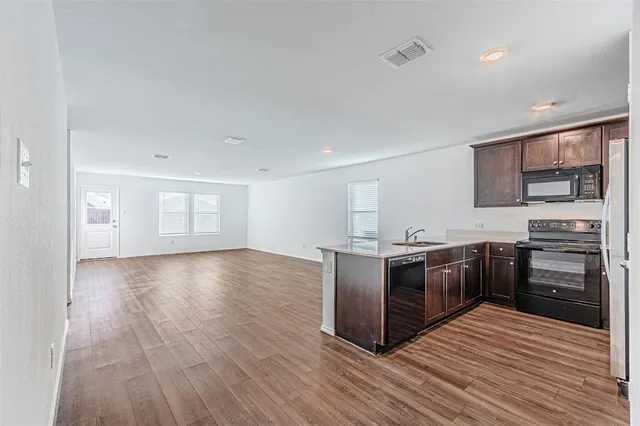 a kitchen with stainless steel appliances granite countertop a stove and a sink