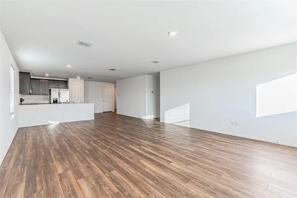 a view of a kitchen with wooden floor and a kitchen