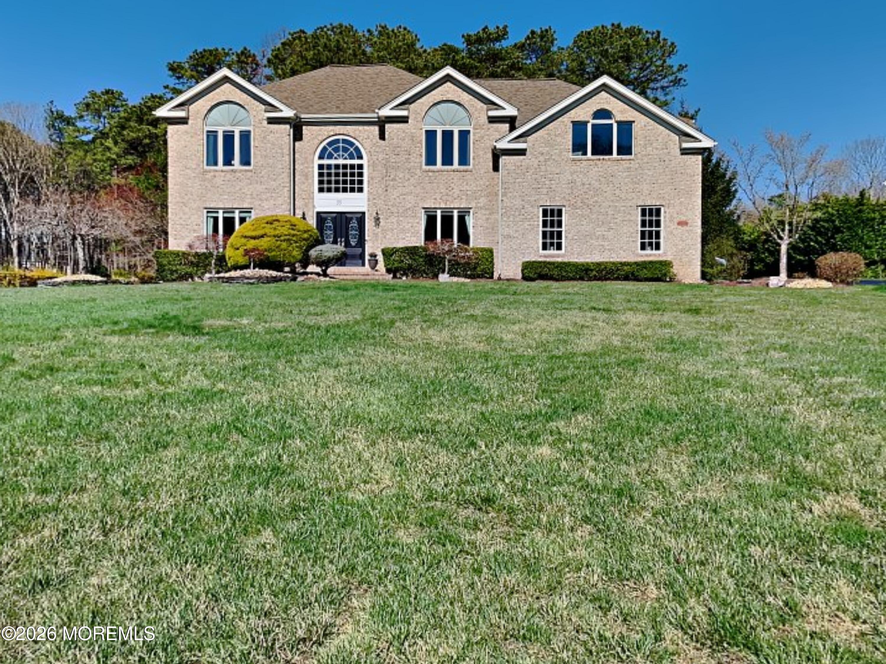 a view of house with yard and green space