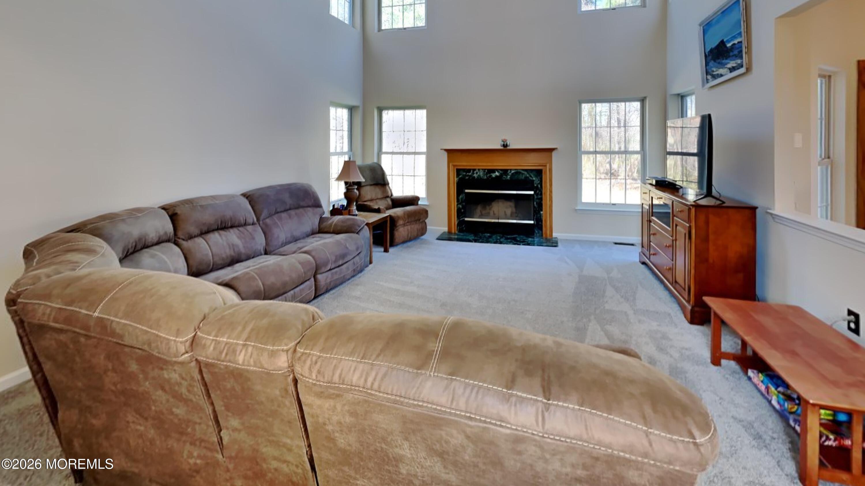 33 Mill Pond Road Jackson, NJ 08527 - Photo 16 of 49 a living room with furniture a window and a fireplace