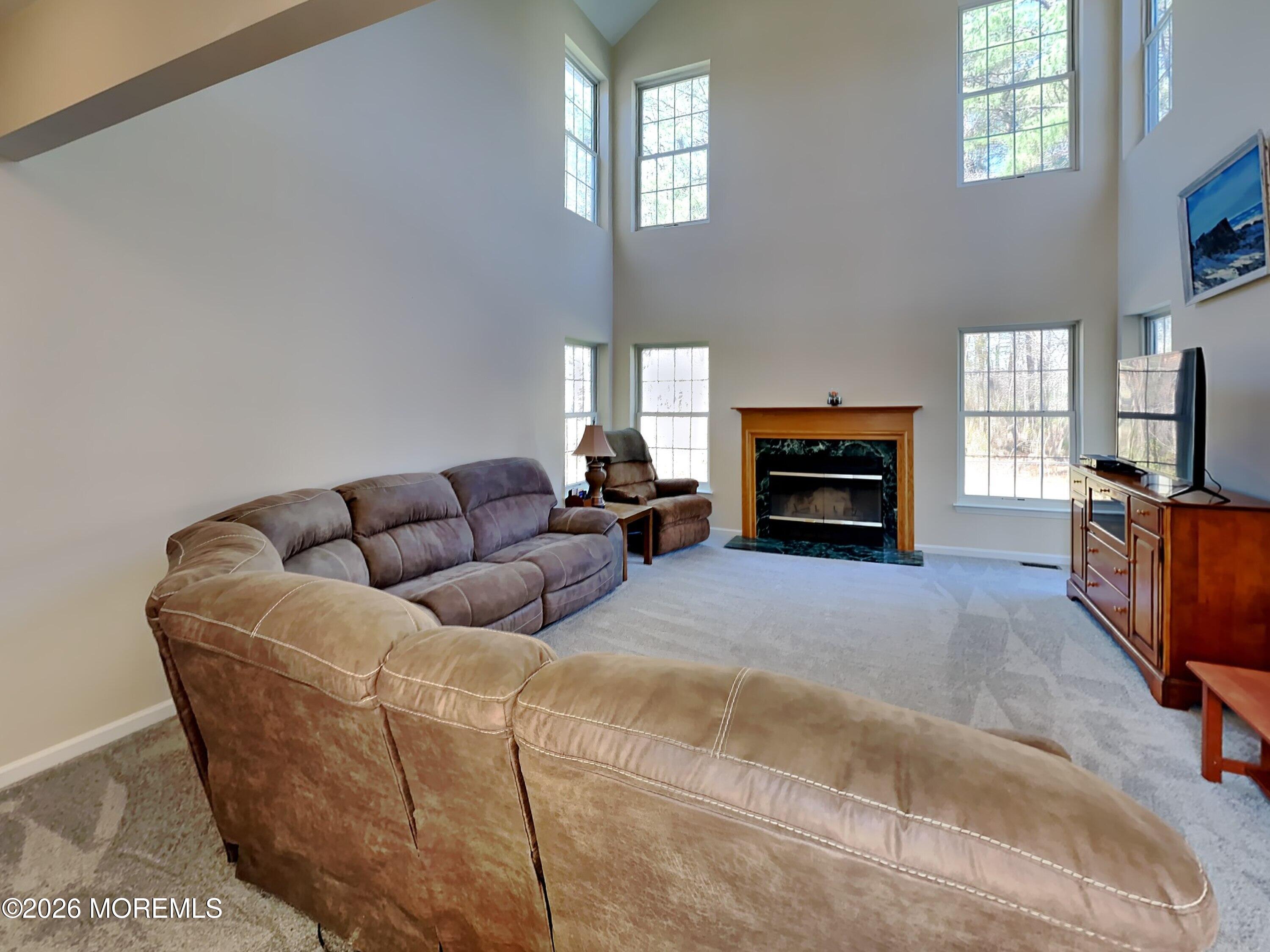 33 Mill Pond Road Jackson, NJ 08527 - Photo 18 of 49 a living room with furniture a fireplace and a flat screen tv