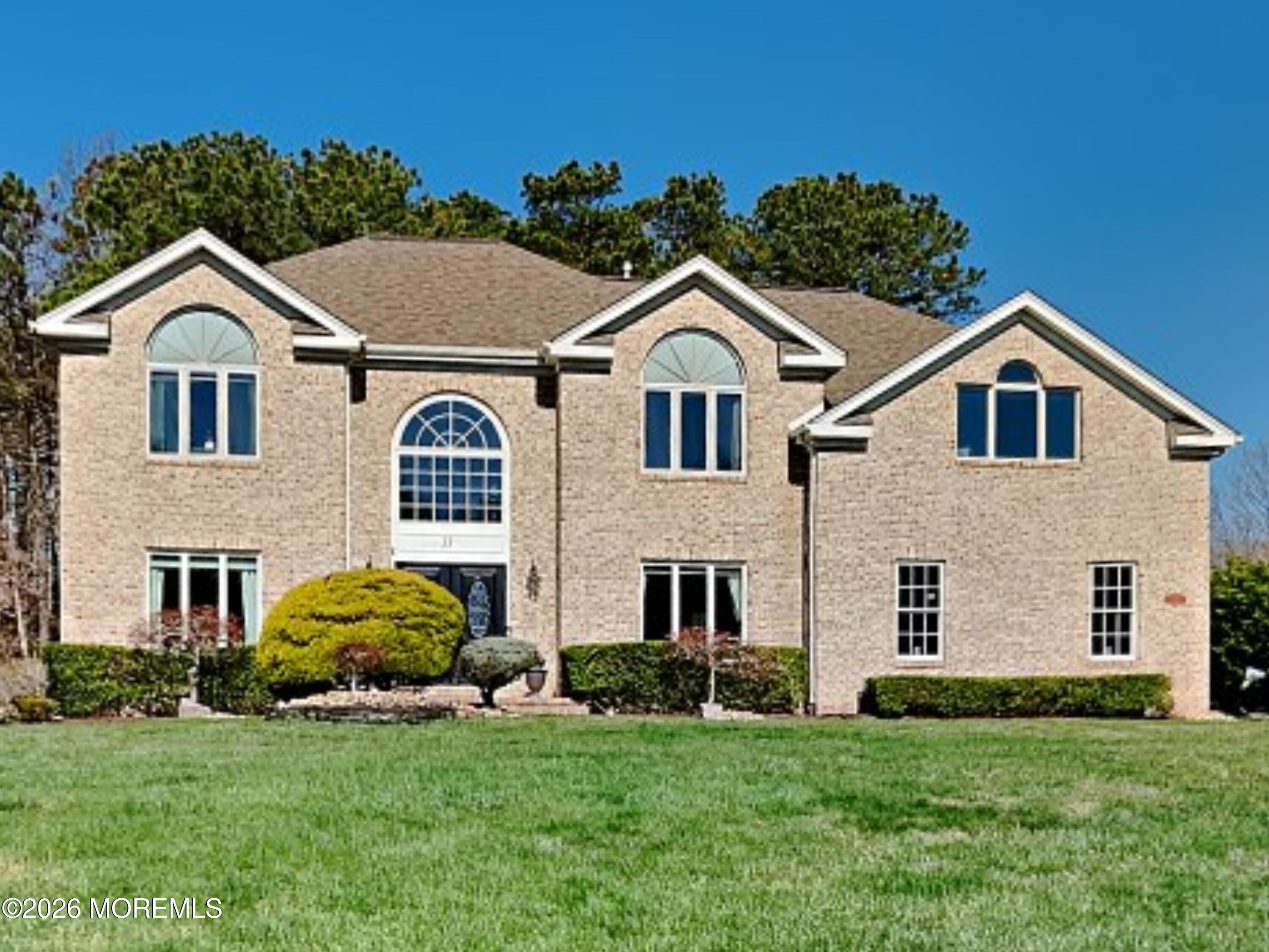 33 Mill Pond Road Jackson, NJ 08527 - Photo 2 of 49 a view of a brick house with a yard