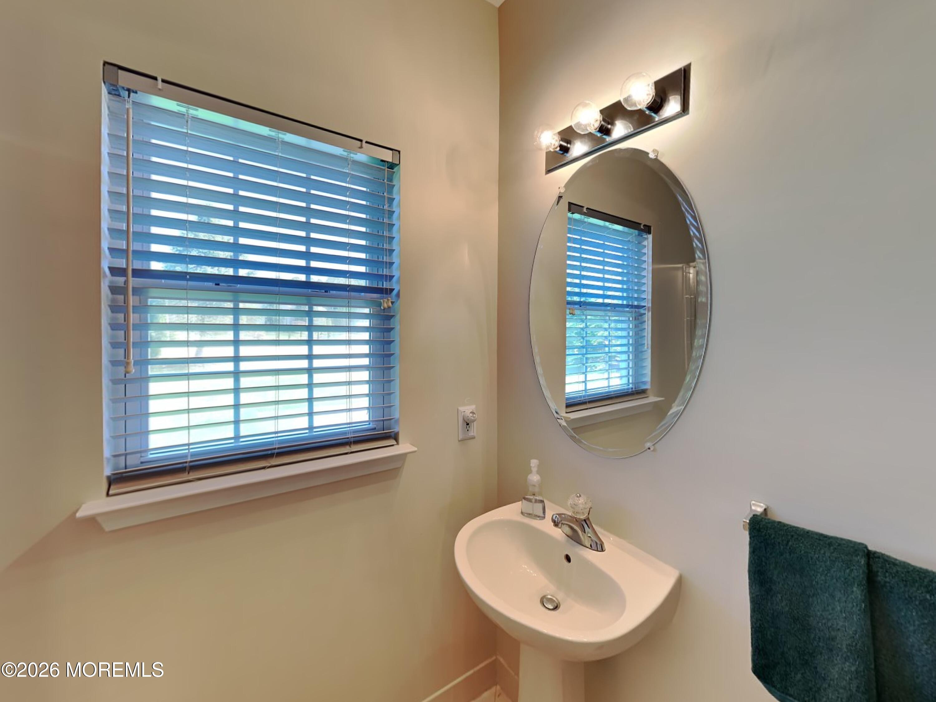 33 Mill Pond Road Jackson, NJ 08527 - Photo 27 of 49 a bathroom with a sink a mirror and a window