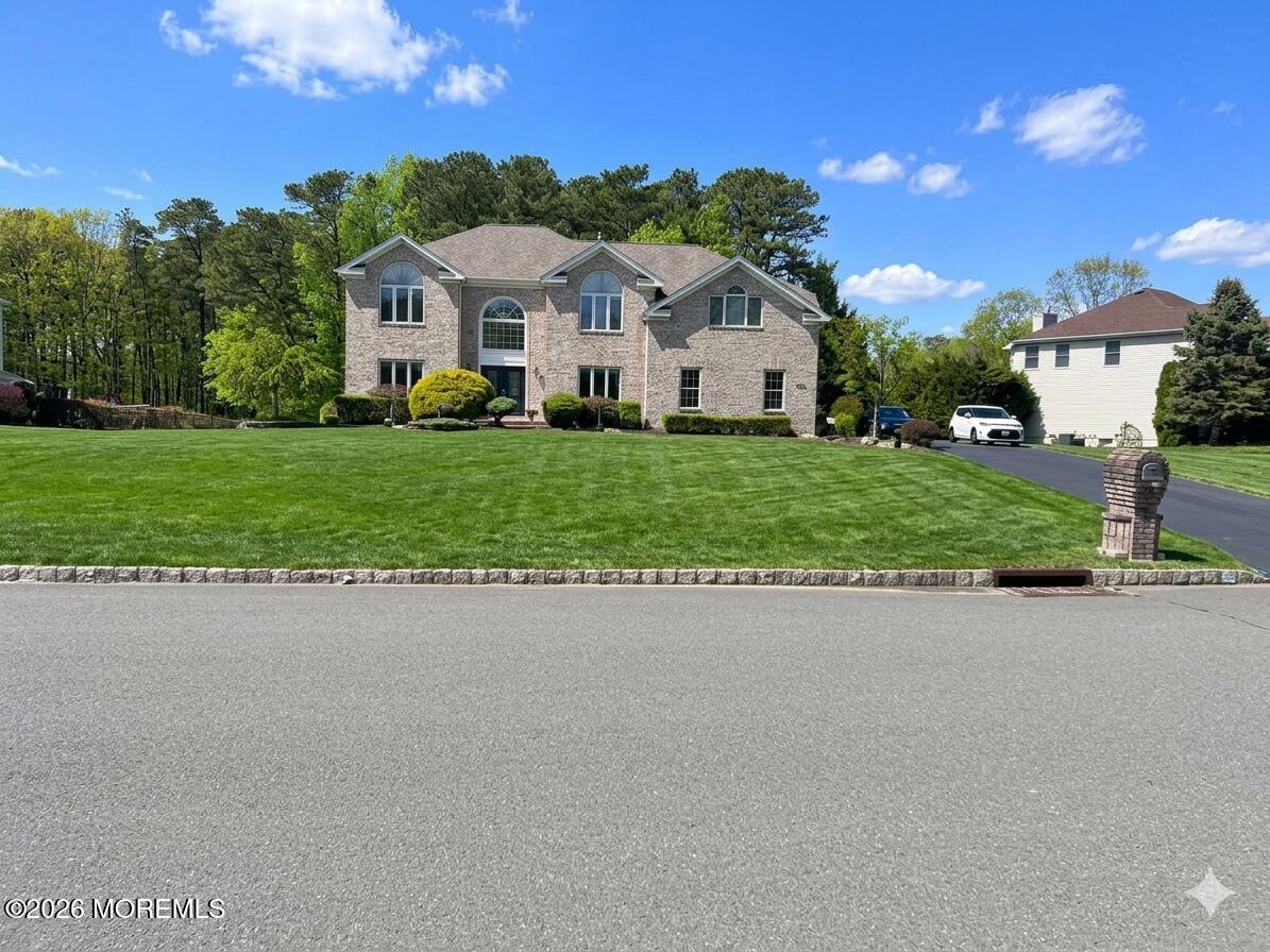 33 Mill Pond Road Jackson, NJ 08527 - Photo 47 of 49 a front view of a house with a yard and garage