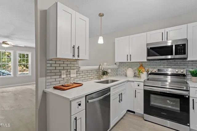 a kitchen with a sink stove and microwave