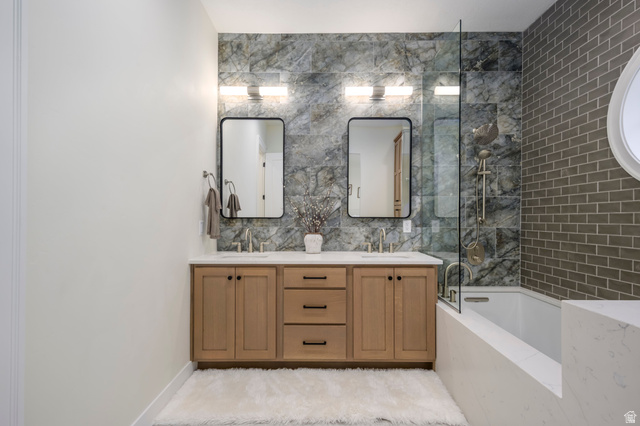 250 South Main Street, Unit 25 Alpine, UT 84004 - Photo 21 of 31 Bathroom featuring double vanity, bathing tub / shower combination, and tile walls