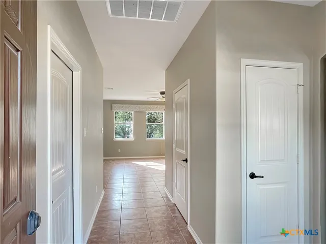 a view of a hallway with a wooden door