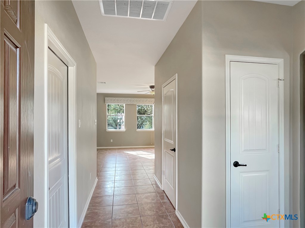 403 Red Hawk Drive Leander, TX 78641 - Photo 15 of 35 a view of a hallway with a wooden door