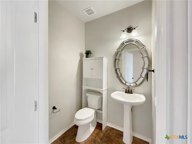 a bathroom with a toilet and a sink