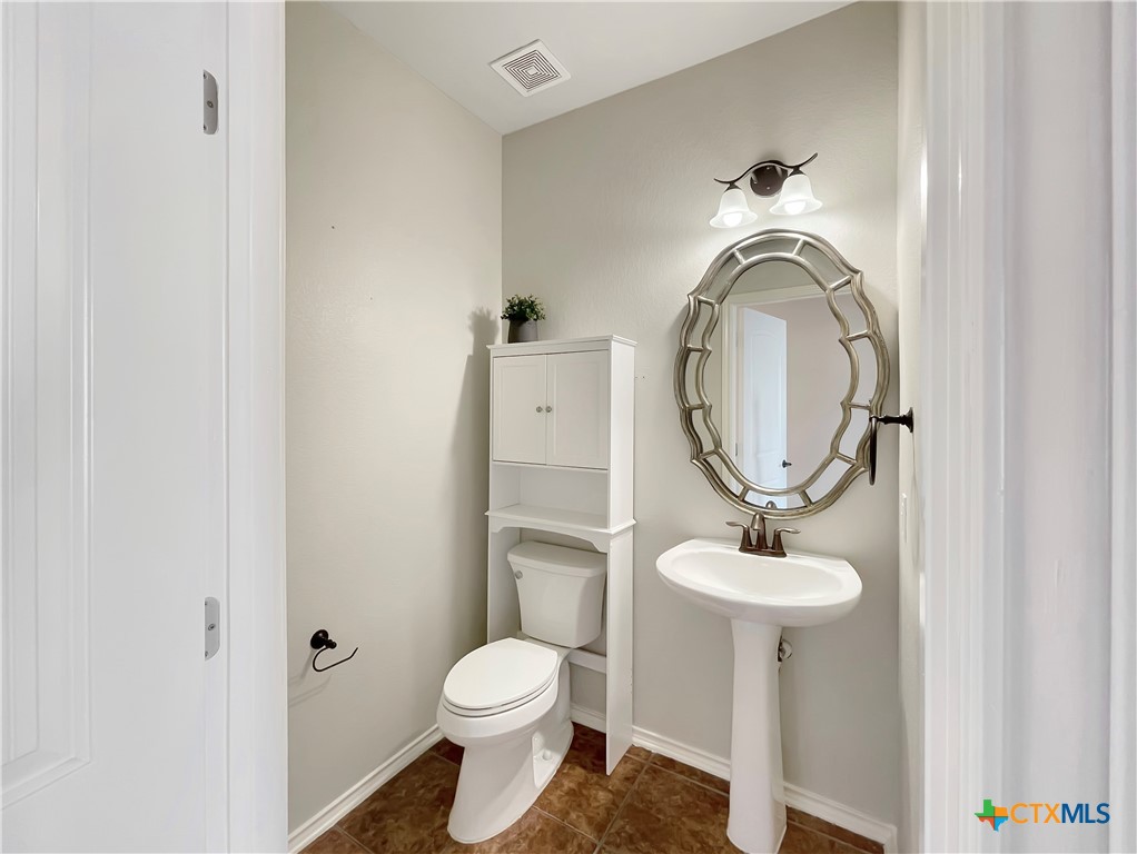 403 Red Hawk Drive Leander, TX 78641 - Photo 18 of 35 a bathroom with a toilet and a sink