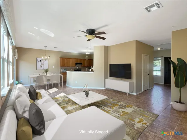 a view of a livingroom with furniture and a flat screen tv