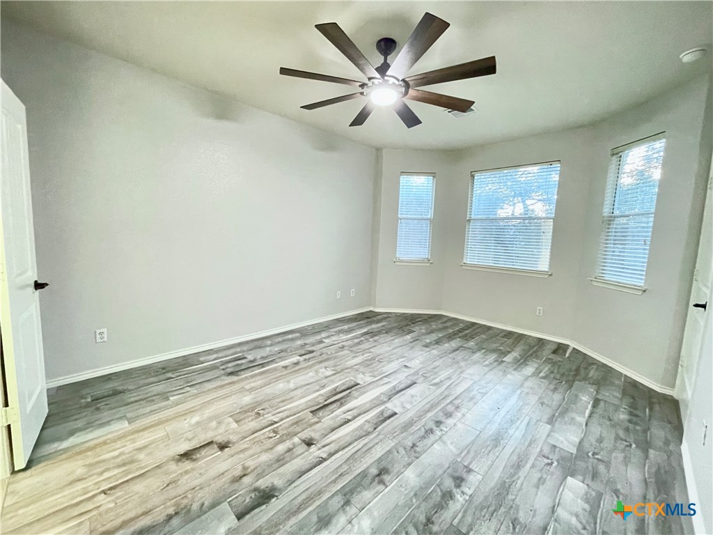 403 Red Hawk Drive Leander, TX 78641 - Photo 24 of 35 an empty room with wooden floor and windows