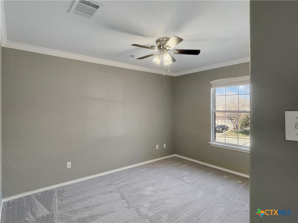 403 Red Hawk Drive Leander, TX 78641 - Photo 29 of 35 an empty room with windows and fan