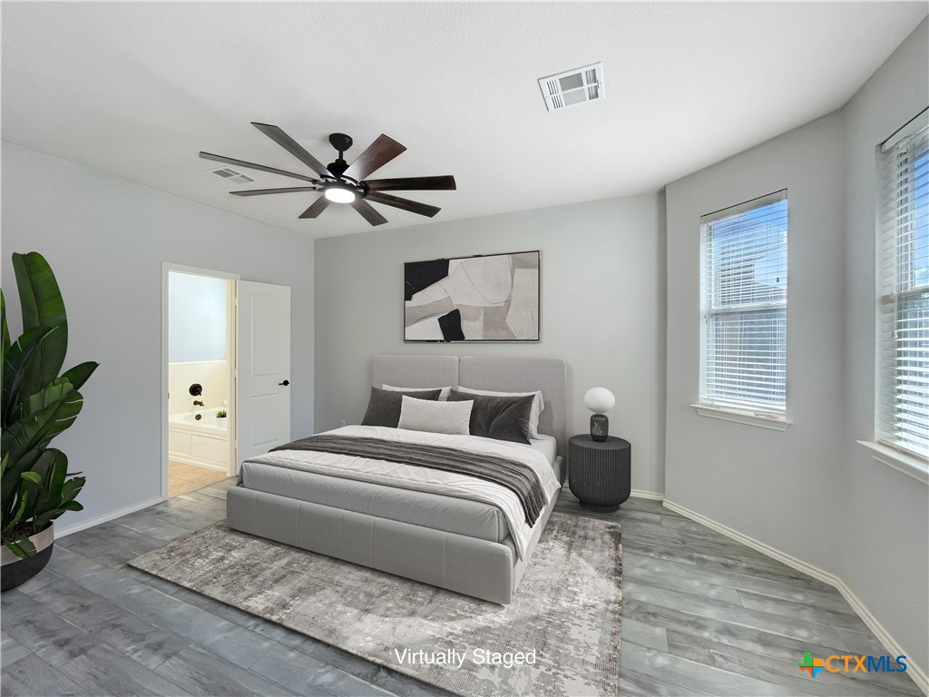 403 Red Hawk Drive Leander, TX 78641 - Photo 4 of 35 a bedroom with a bed and a chandelier