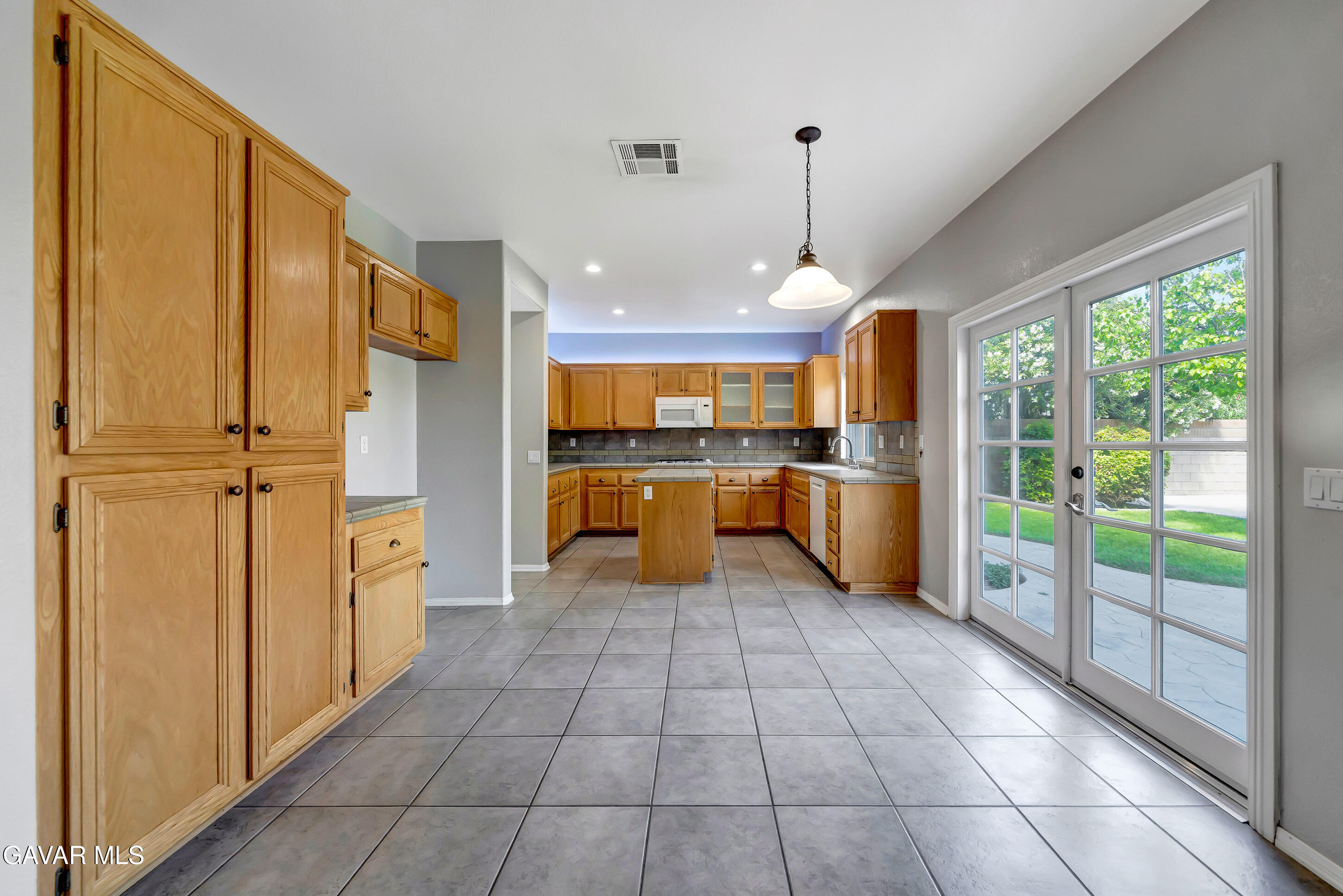 43826 Generation Avenue Lancaster, CA 93536 - Photo 19 of 61 a large kitchen with stainless steel appliances granite countertop a refrigerator and a stove top oven