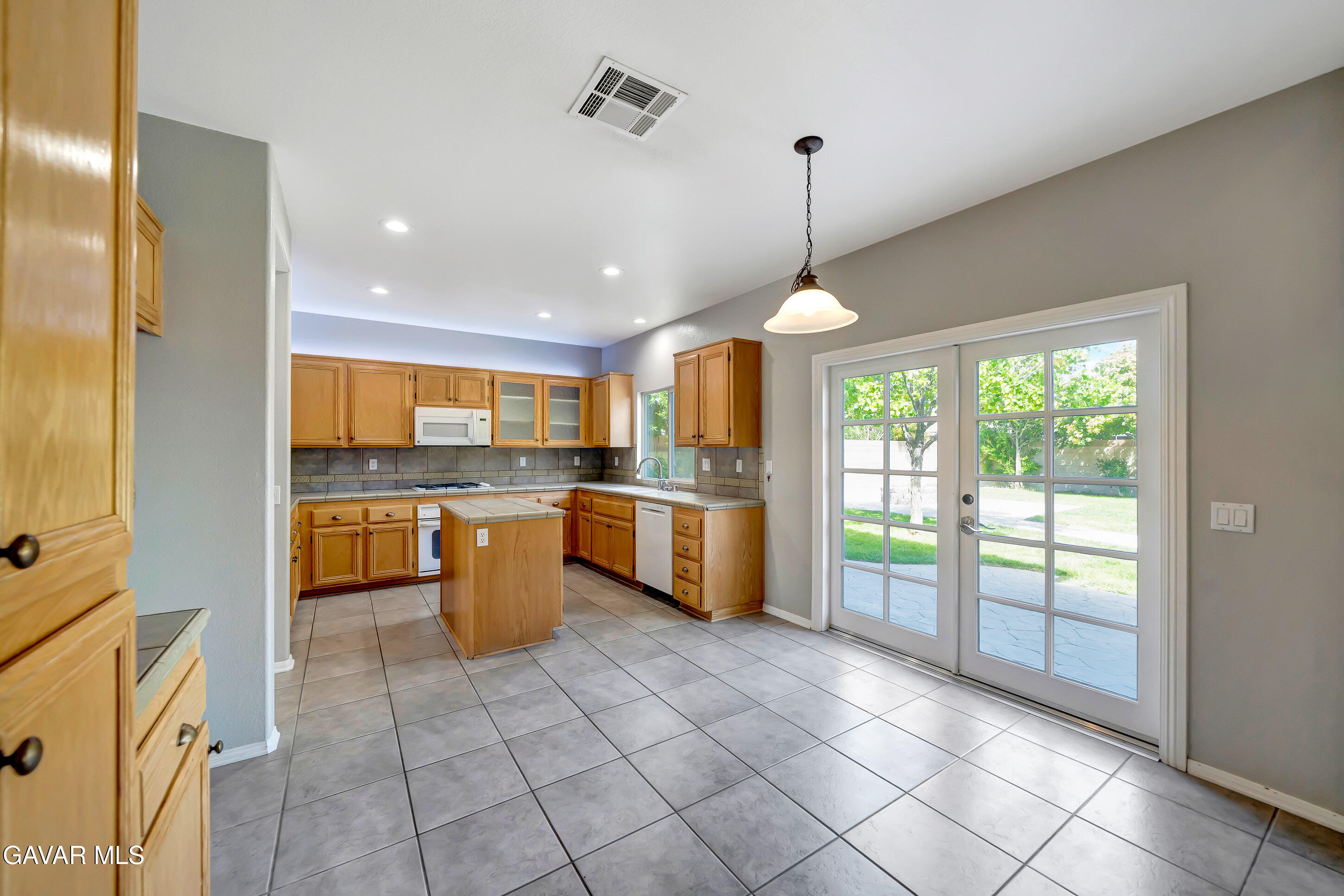 43826 Generation Avenue Lancaster, CA 93536 - Photo 20 of 61 a kitchen with a stove a sink and a refrigerator