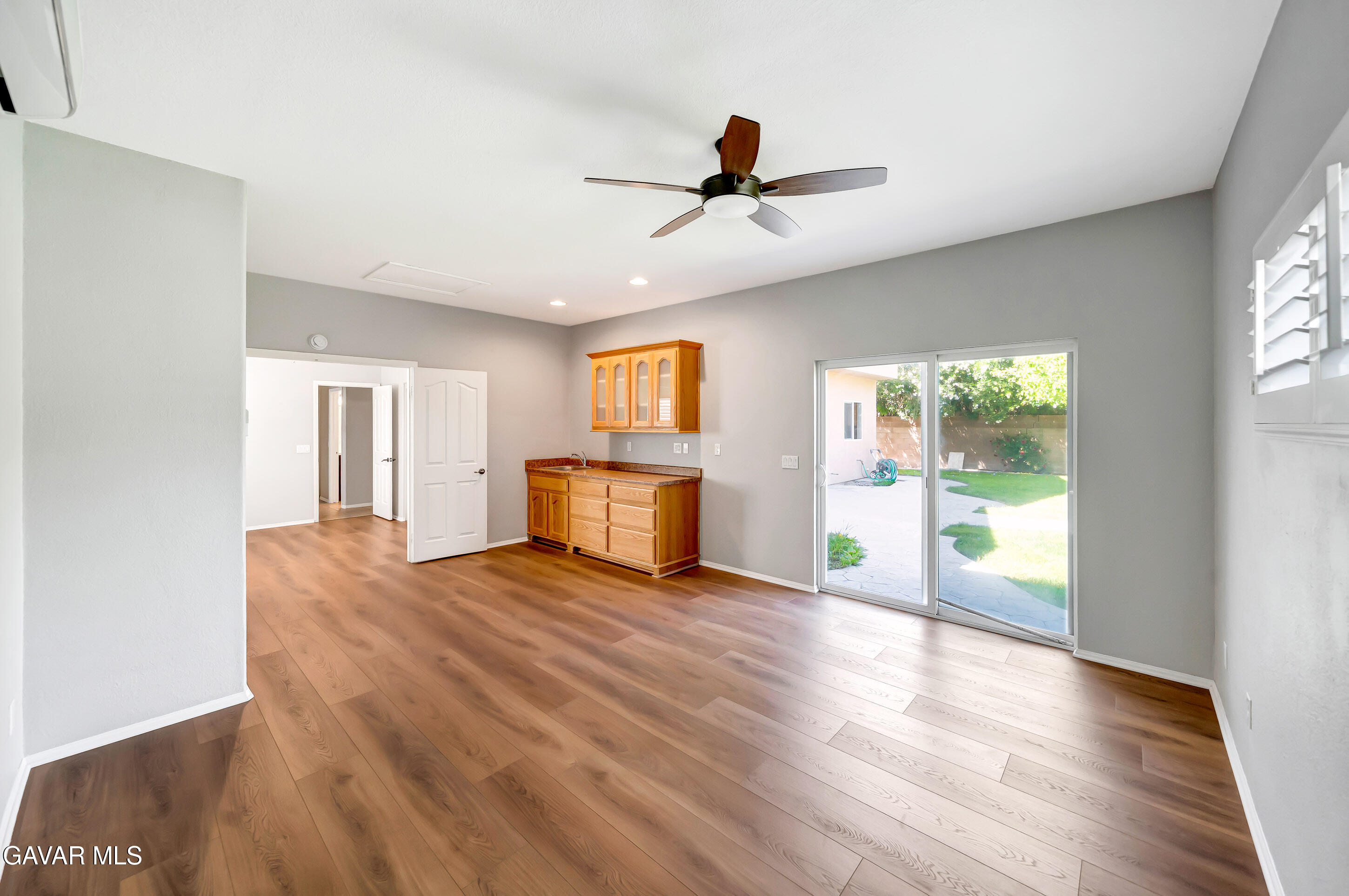 43826 Generation Avenue Lancaster, CA 93536 - Photo 30 of 61 a view of a livingroom with wooden floor a ceiling fan and windows