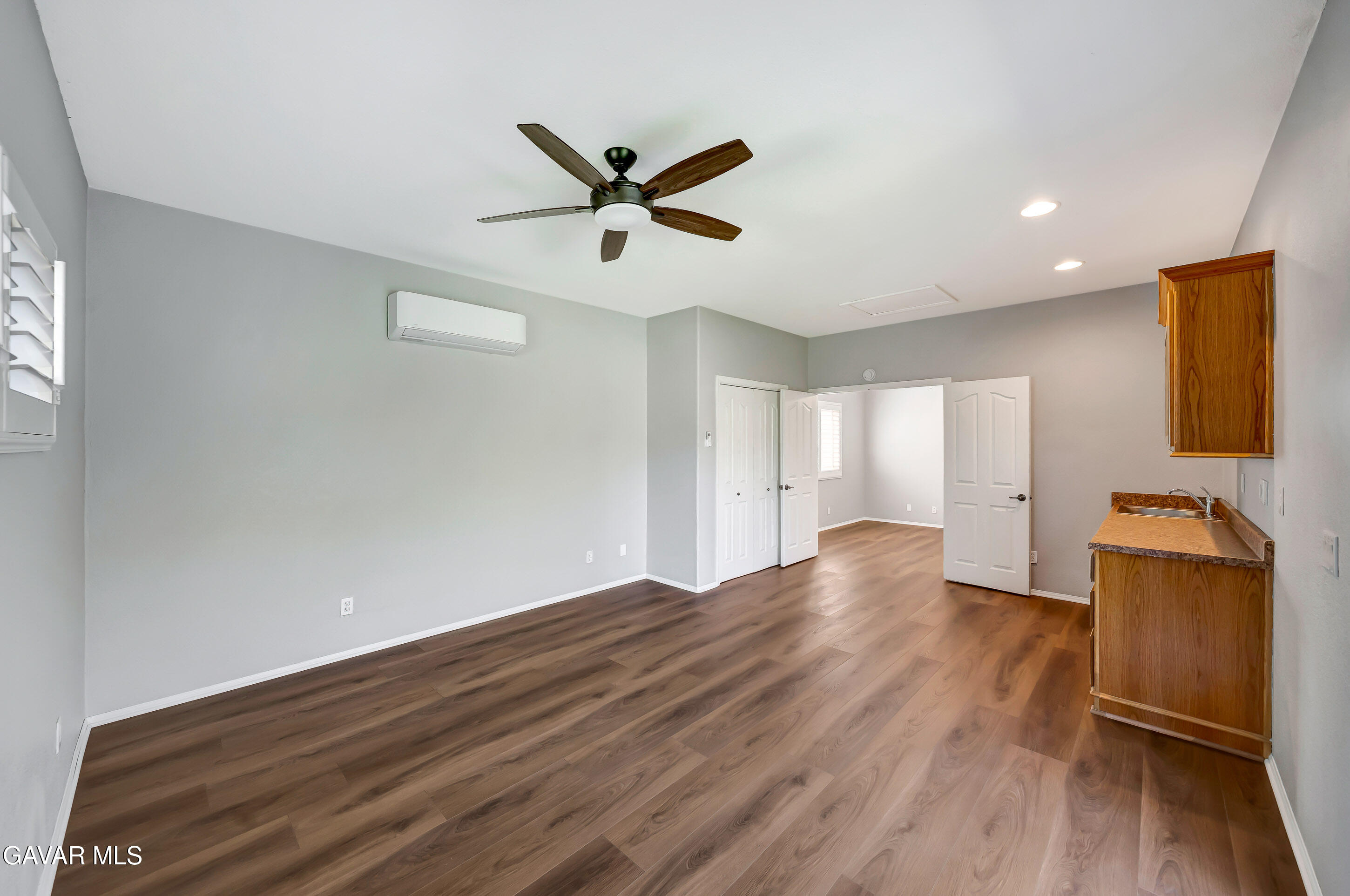 43826 Generation Avenue Lancaster, CA 93536 - Photo 31 of 61 a view of empty room with wooden floor and fan