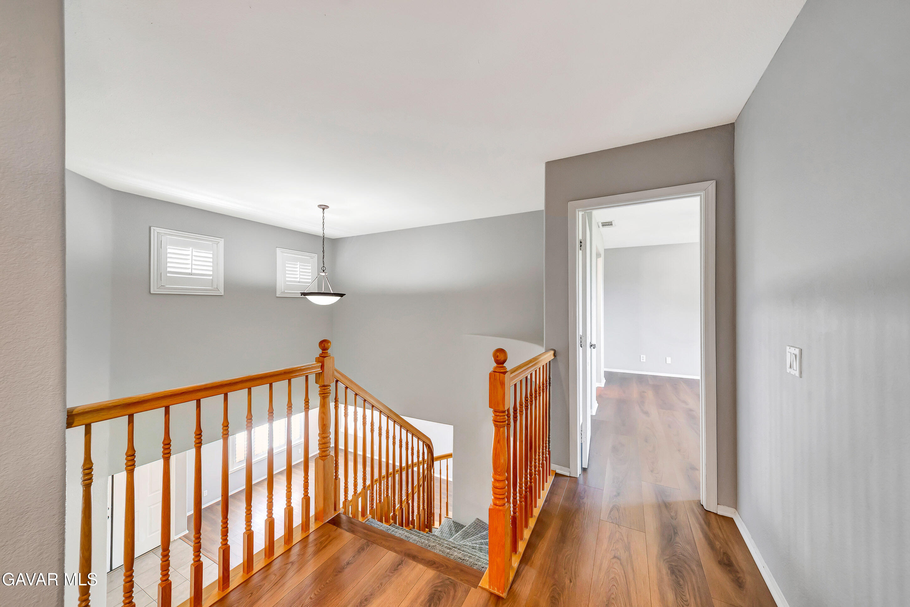 43826 Generation Avenue Lancaster, CA 93536 - Photo 36 of 61 a view of a hallway with wooden floor and staircase