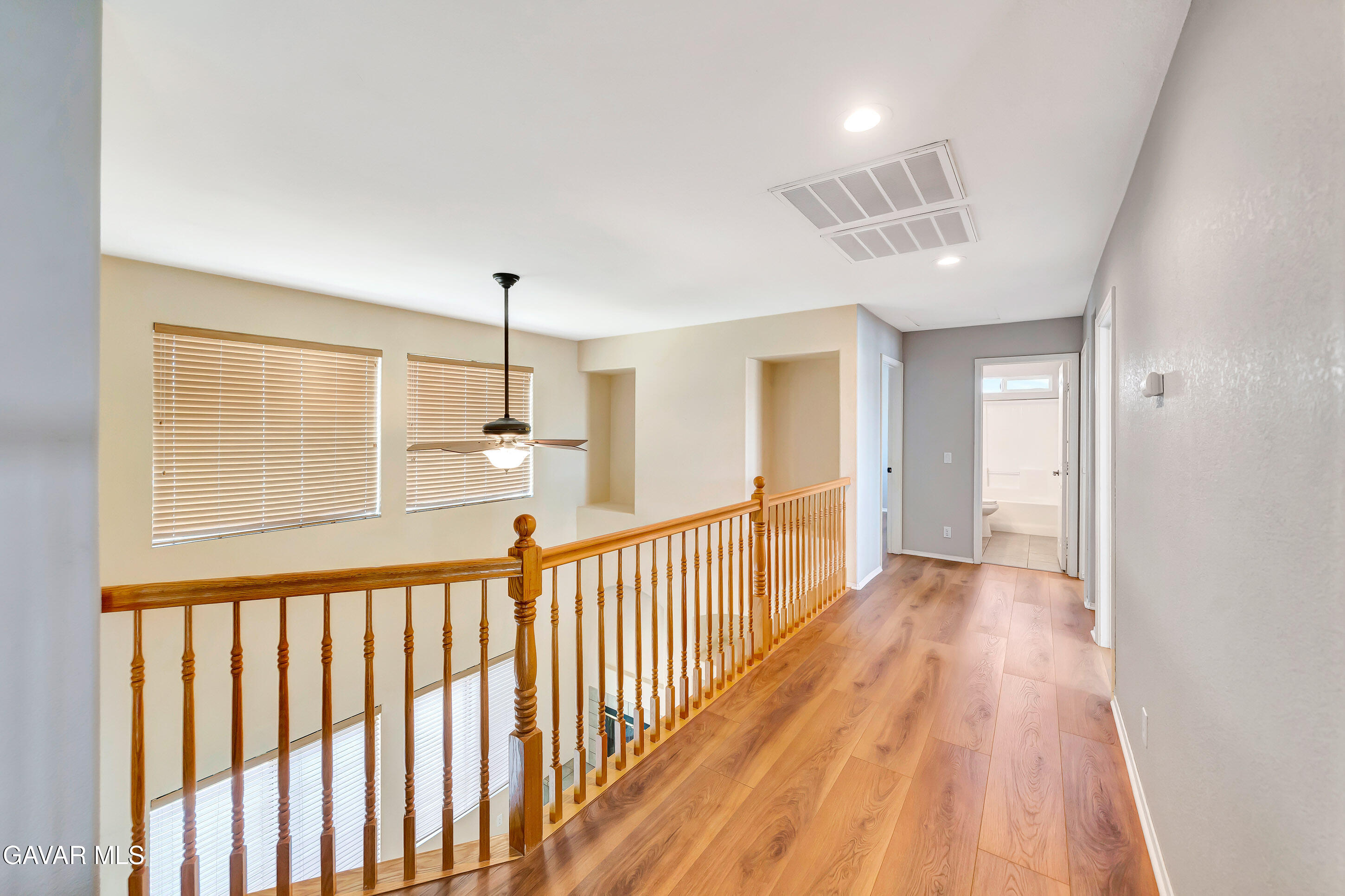 43826 Generation Avenue Lancaster, CA 93536 - Photo 37 of 61 a view of a hallway with wooden floor and staircase