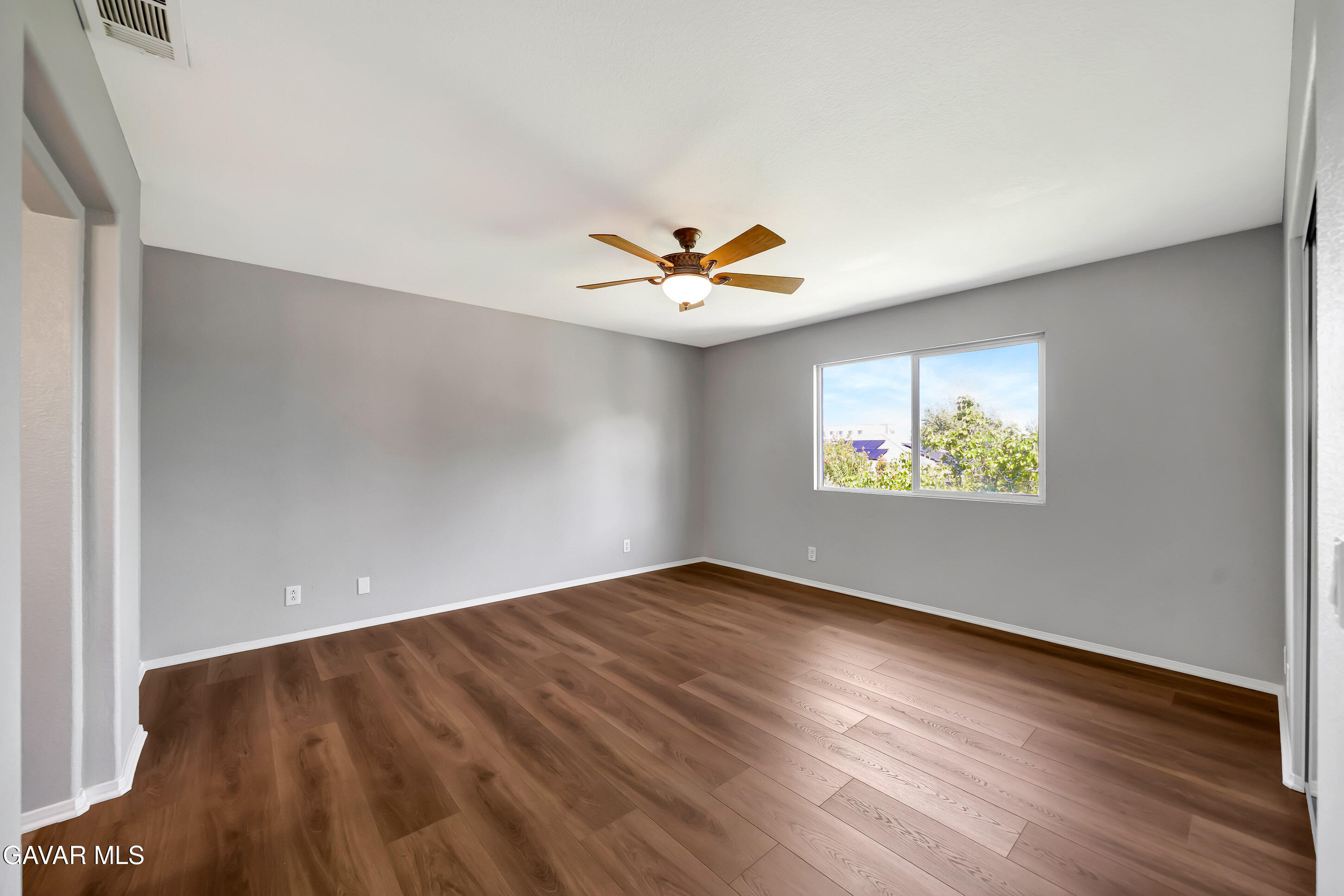 43826 Generation Avenue Lancaster, CA 93536 - Photo 38 of 61 an empty room with wooden floor and ceiling fan