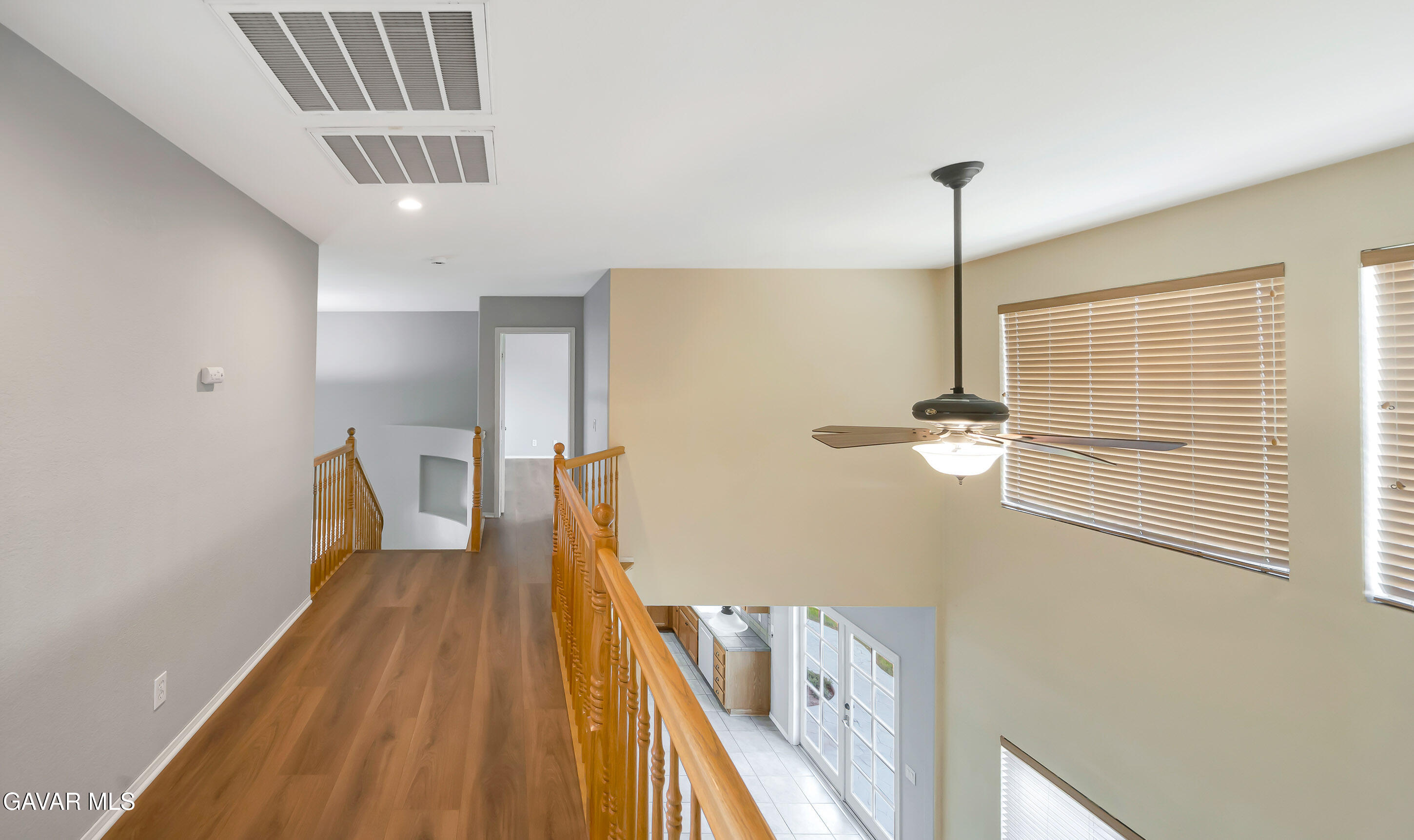 43826 Generation Avenue Lancaster, CA 93536 - Photo 45 of 61 a view of a hallway with wooden floor and staircase
