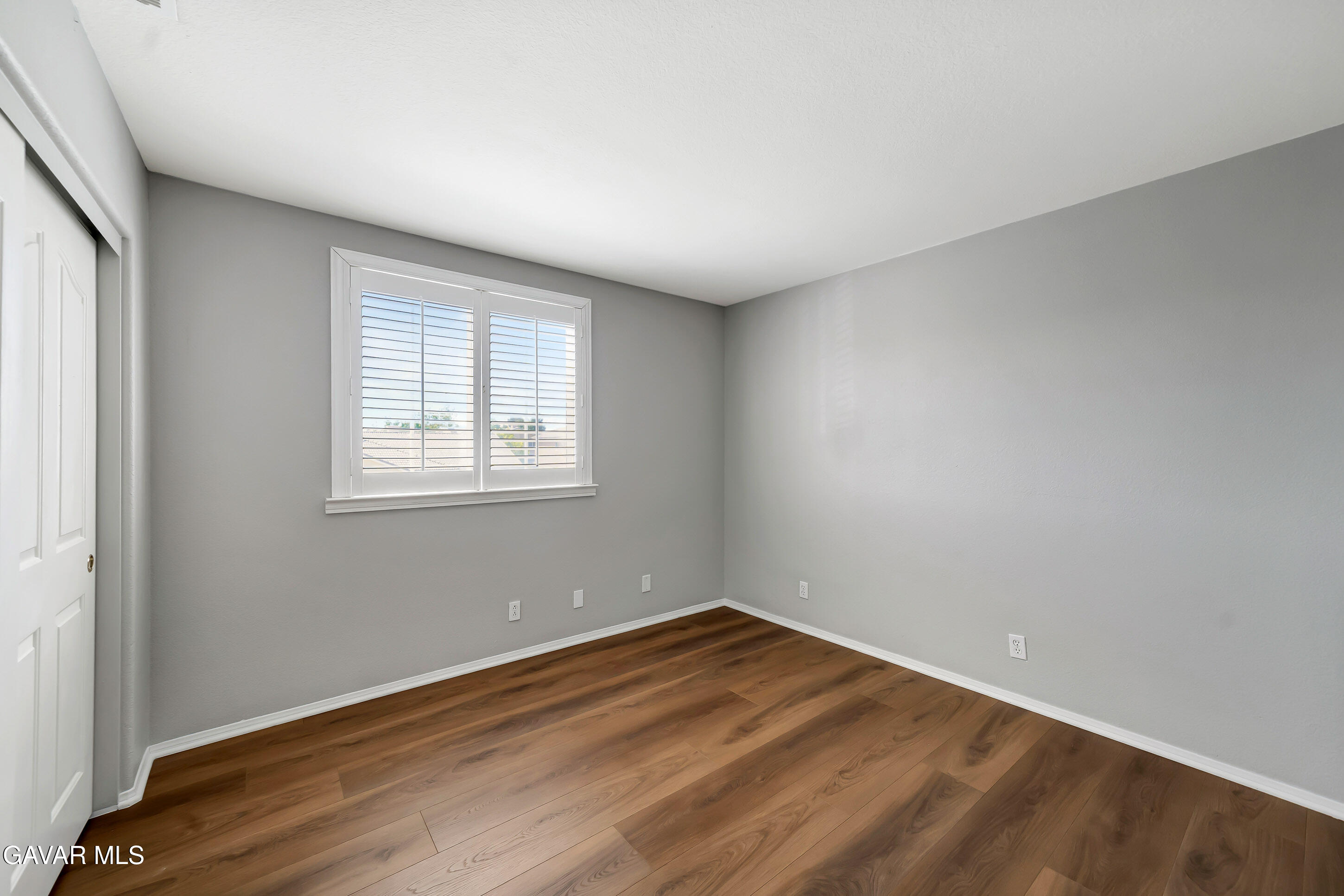 43826 Generation Avenue Lancaster, CA 93536 - Photo 46 of 61 an empty room with wooden floor and windows