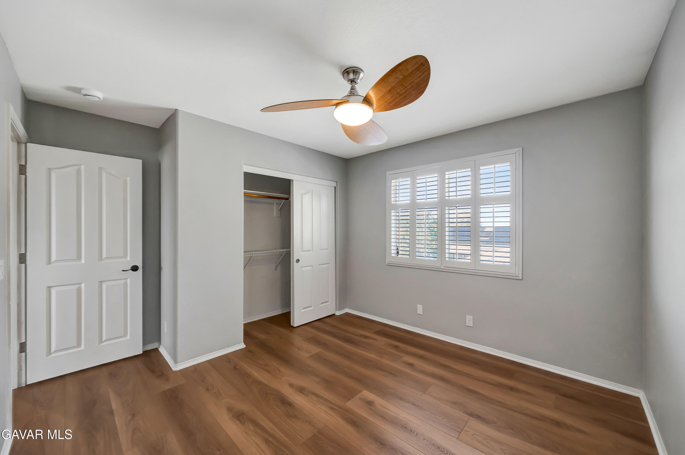 43826 Generation Avenue Lancaster, CA 93536 - Photo 53 of 61 a view of an empty room with wooden floor and a window