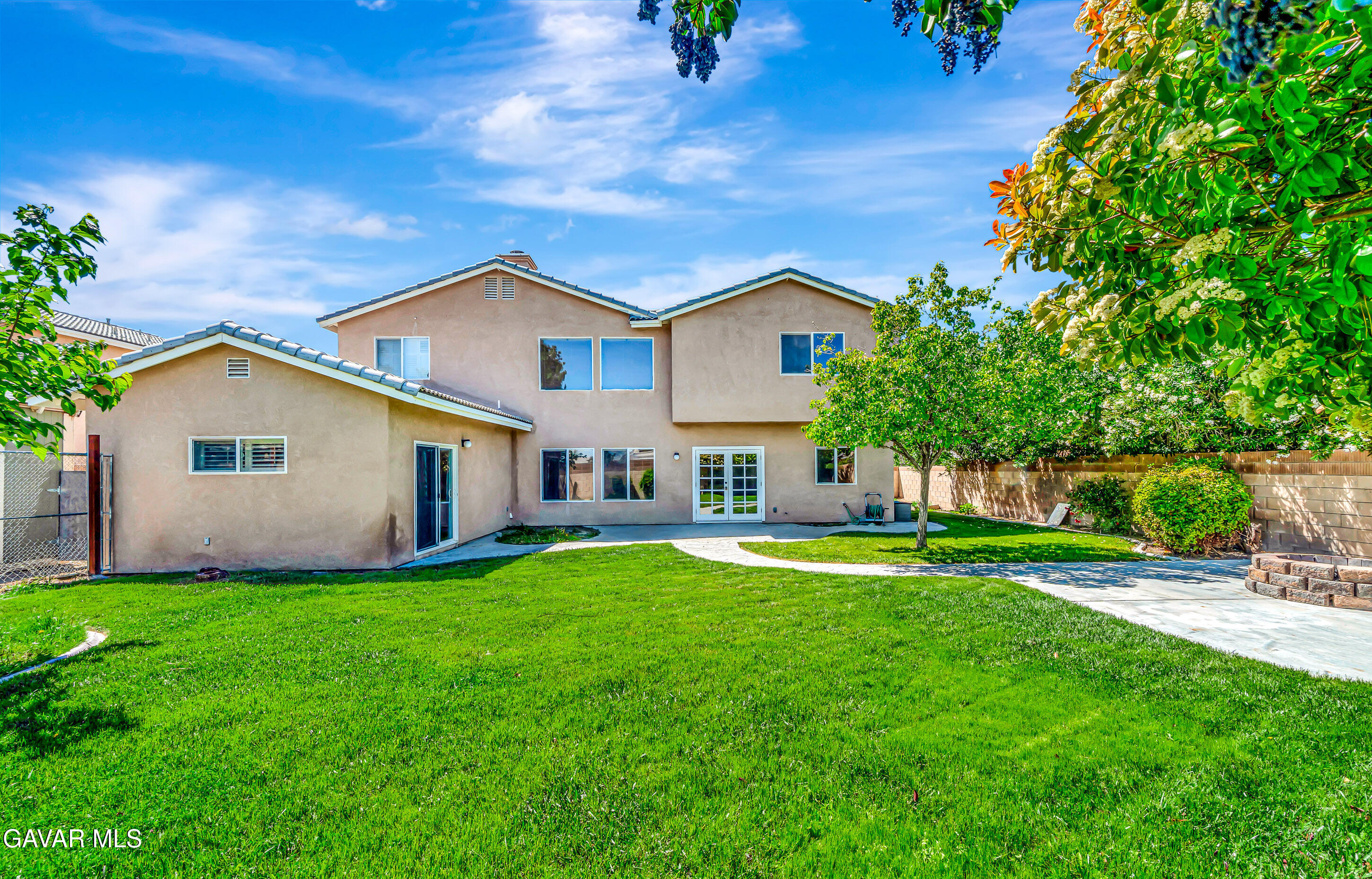43826 Generation Avenue Lancaster, CA 93536 - Photo 54 of 61 a front view of a house with a yard and trees
