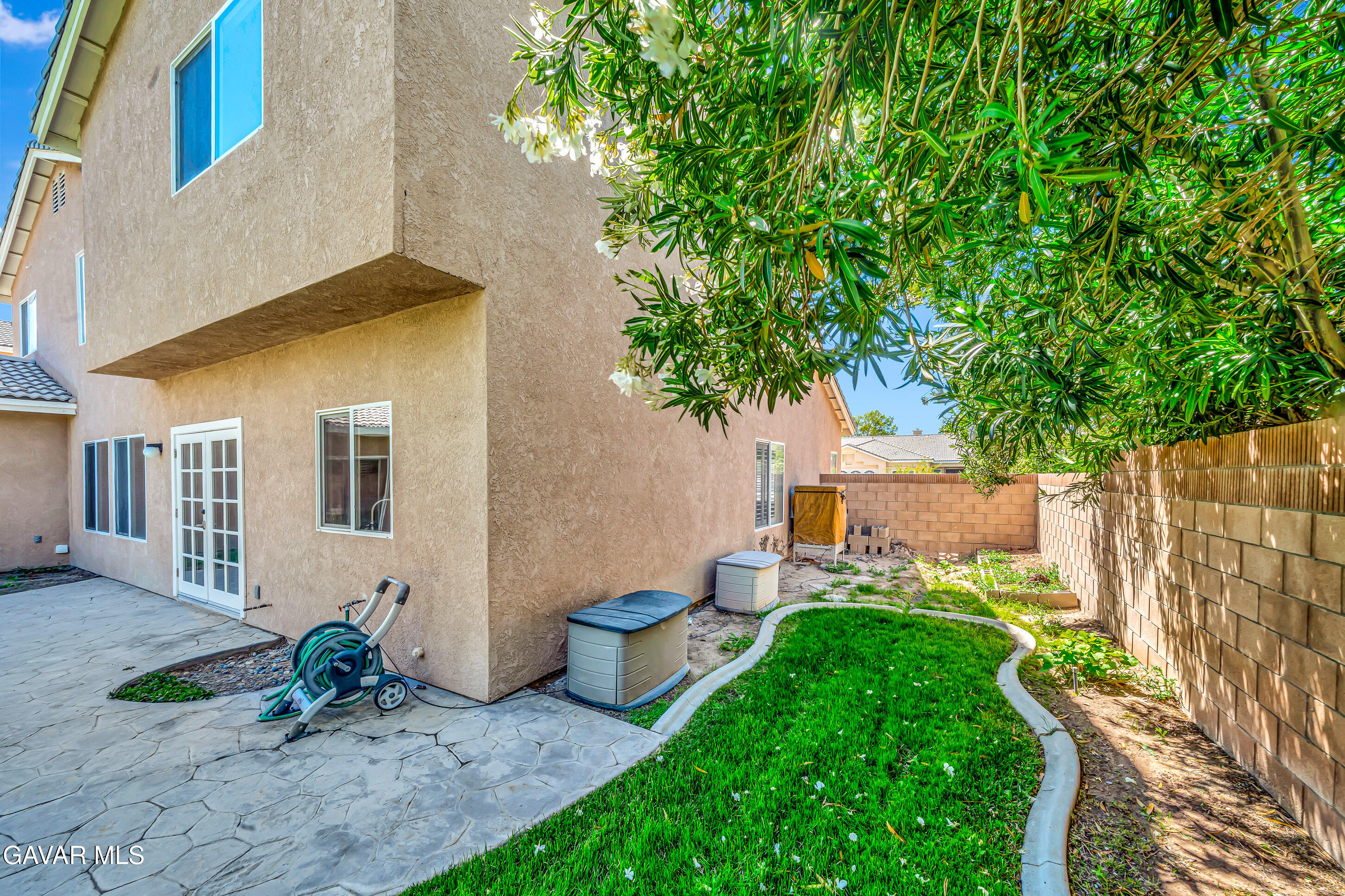 43826 Generation Avenue Lancaster, CA 93536 - Photo 57 of 61 a view of a house with a yard and table and chairs in patio
