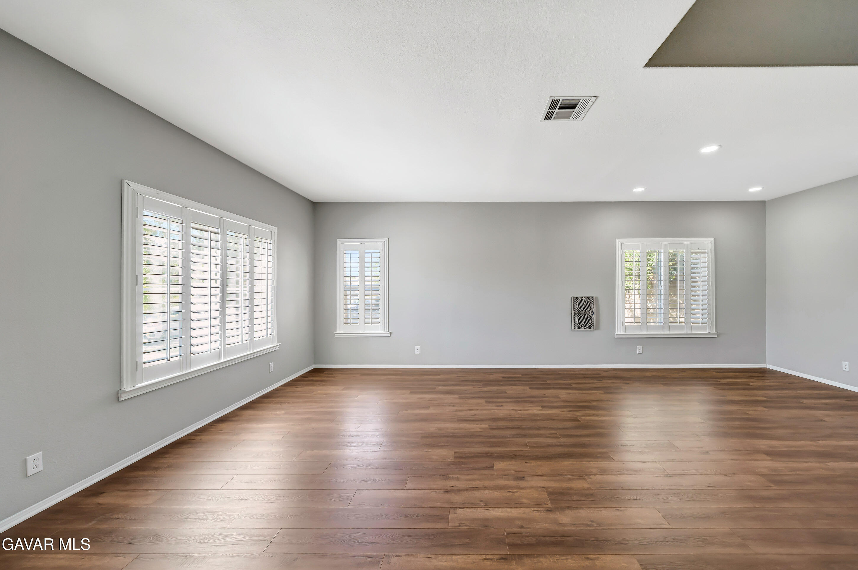 43826 Generation Avenue Lancaster, CA 93536 - Photo 6 of 61 a view of an empty room with wooden floor and a window