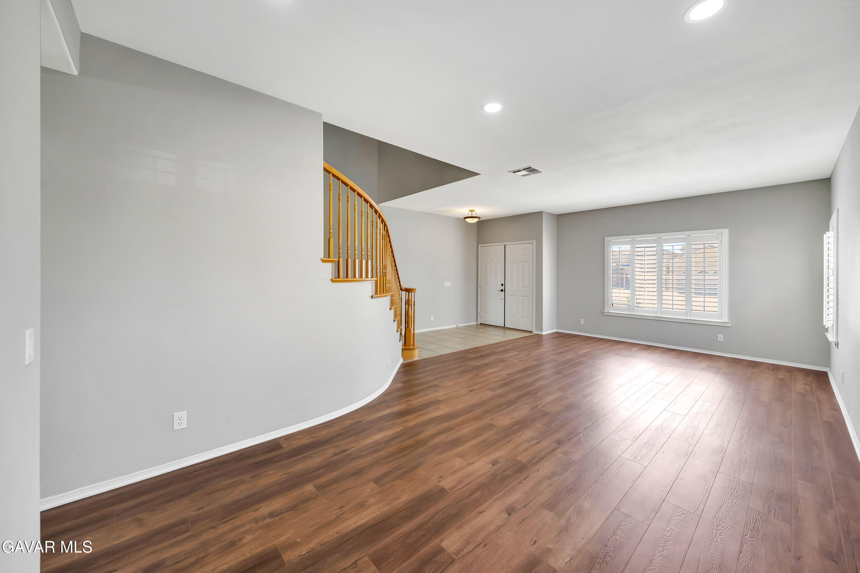 43826 Generation Avenue Lancaster, CA 93536 - Photo 7 of 61 an empty room with wooden floor and windows
