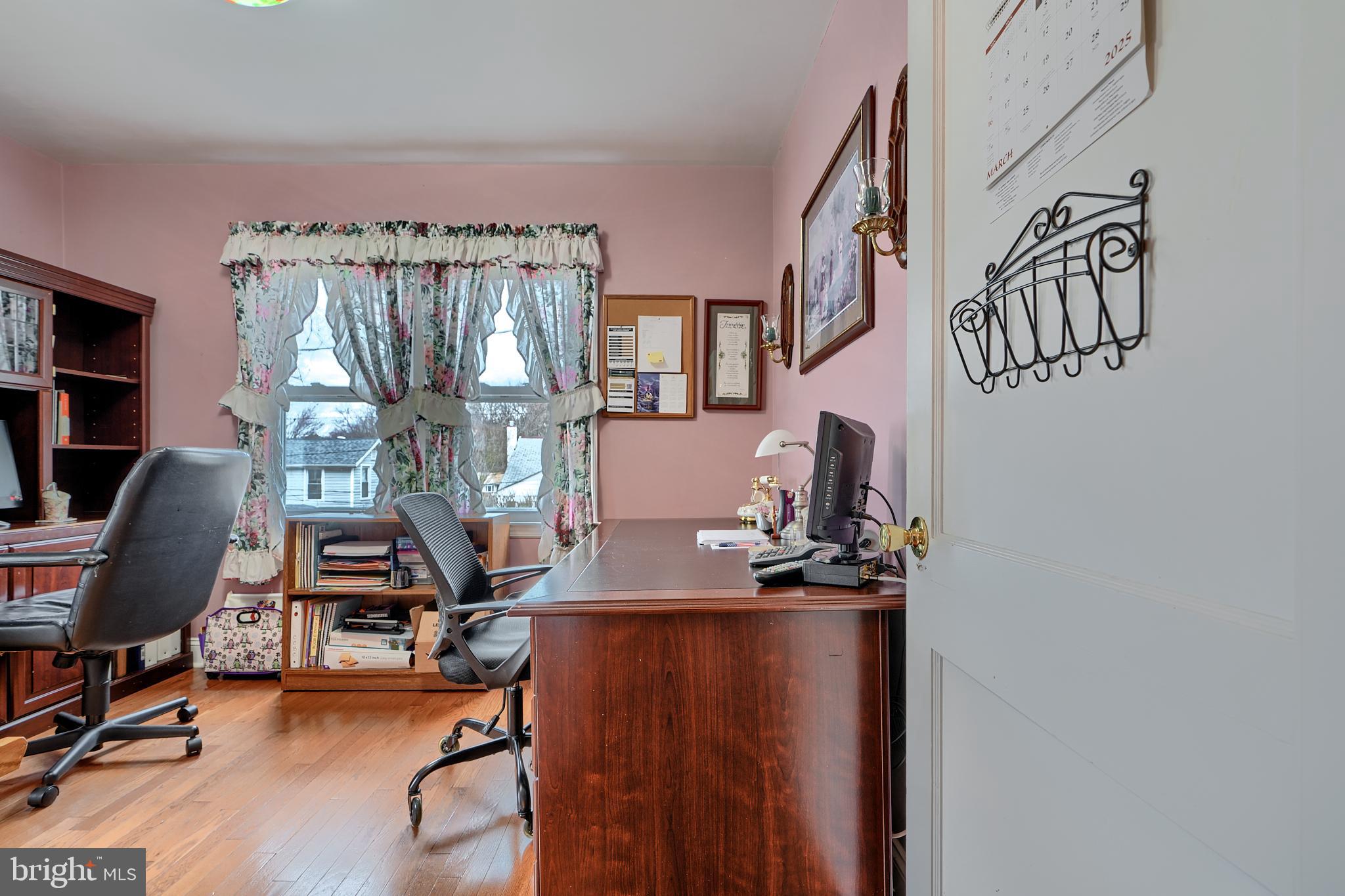 297 Hazel Avenue Baltimore, MD 21227 - Photo 17 of 56 a view of a workspace with furniture and a window